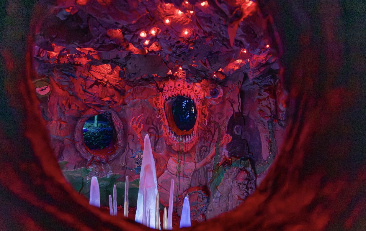 Hidden installation revealing a surreal world of glowing monsters and faces